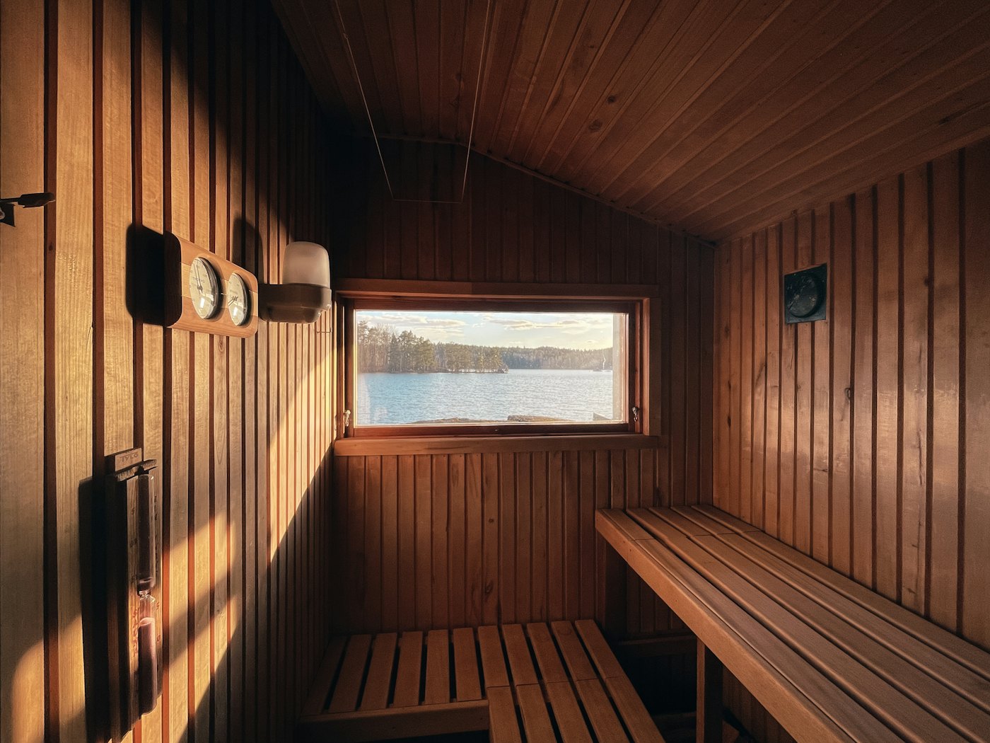 Empty wooden sauna with benches and a small window